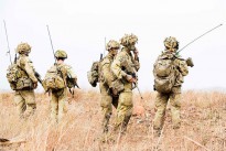 Australian Army officer Lieutenant Colonel Gavin Keating (second right), Commanding Officer, 3rd Battalion, Royal Australian Regiment, surrounded by signallers during the combined arms training activity at Townsville field training area between 1 and 18 June 2015.