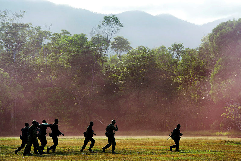 Australian and Indonesian Army soldiers carrying a stretcher during the Junior Officer Combat Instructor Training course conducted by the Australian Army's Combat Training Centre—Jungle Training Wing from 28 September to 10 October 2014.