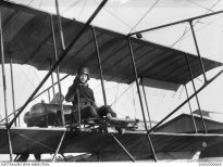 Informal portrait of trainee pilot Captain (Capt) Thomas Walter White, Australian Flying Corps (AFC) at the controls of a Bristol Boxkite at the Central Flying School, Point Cook, Victoria. c.1915